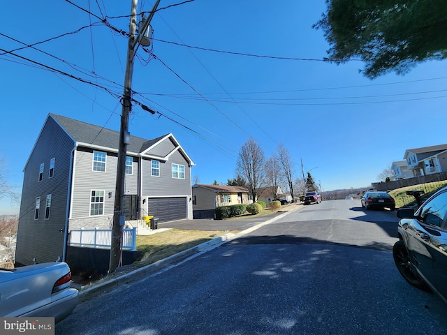 view of road with a residential view and curbs