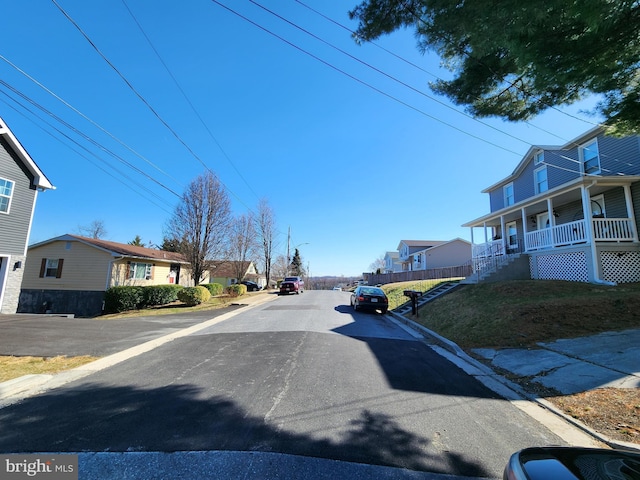 view of road with curbs and a residential view