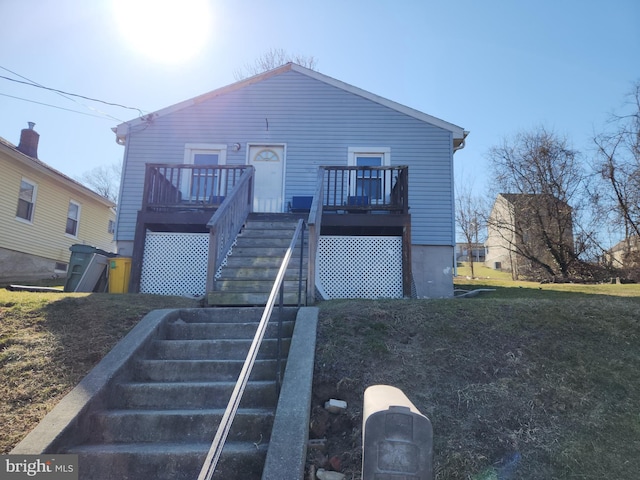 view of front facade with stairway and a deck