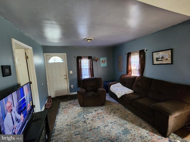 living area featuring wood finished floors, visible vents, and baseboards