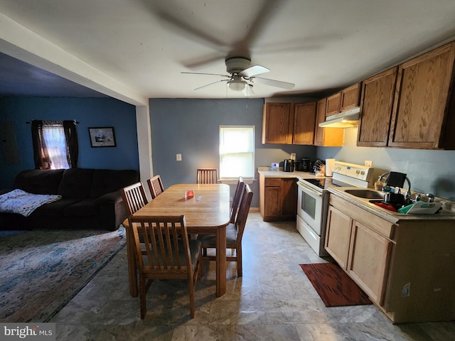 kitchen featuring white electric range, under cabinet range hood, a sink, light countertops, and ceiling fan