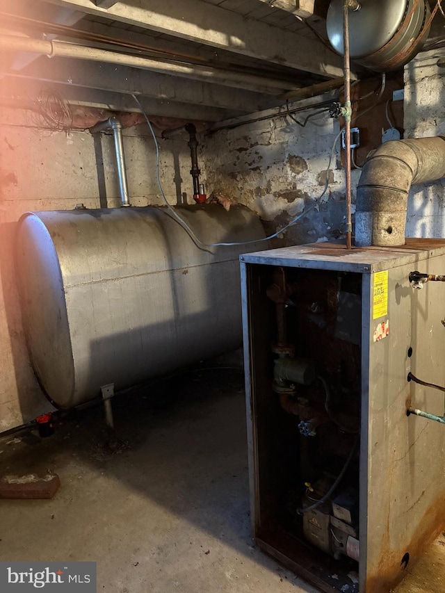 unfinished basement featuring heating fuel and a heating unit