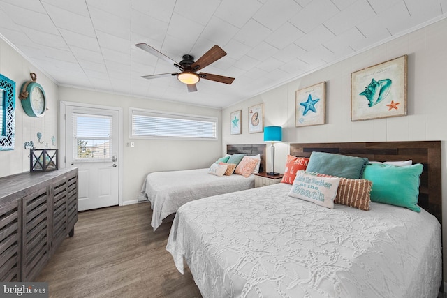 bedroom with multiple windows, ceiling fan, ornamental molding, and wood finished floors