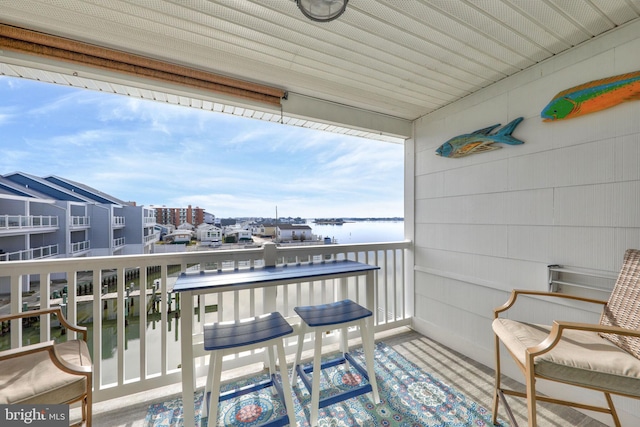 balcony featuring a water view