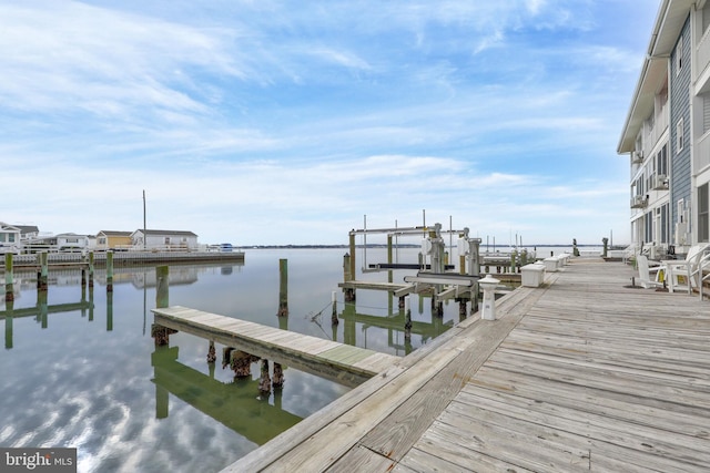 view of dock with boat lift and a water view