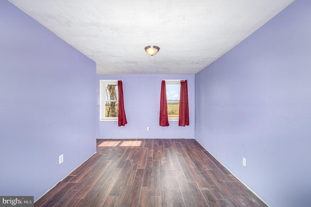 spare room with wood finished floors