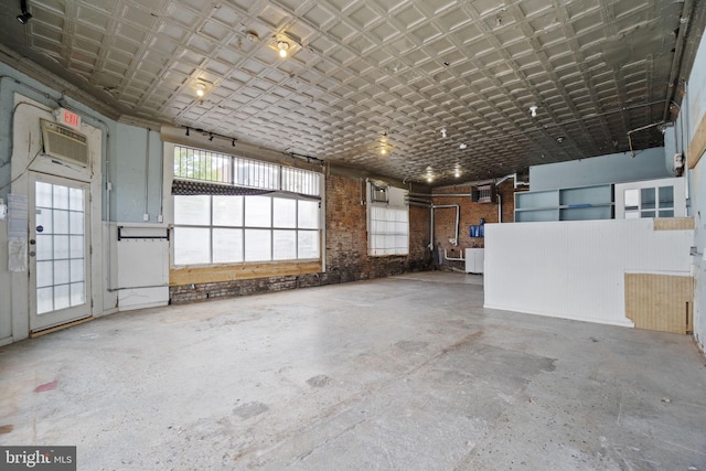 garage with an ornate ceiling and a wall unit AC