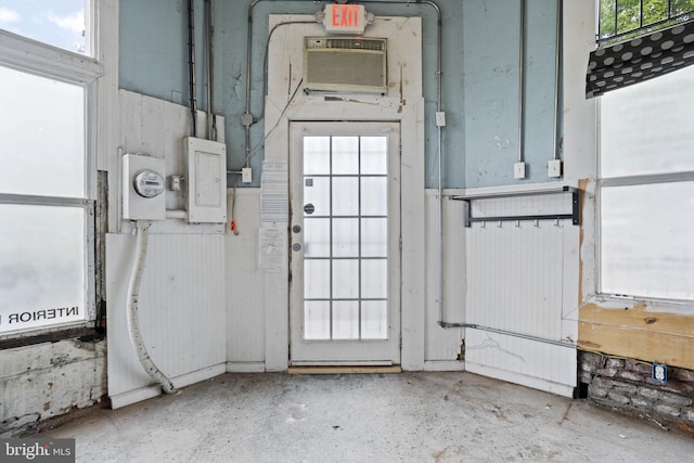 interior space featuring a wealth of natural light and a wall mounted air conditioner