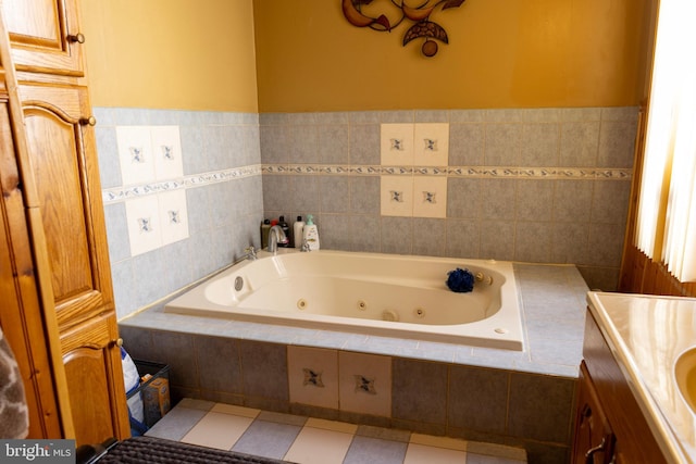 bathroom with a jetted tub, vanity, and tile patterned flooring