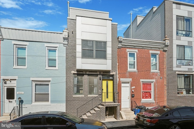 townhome / multi-family property featuring brick siding