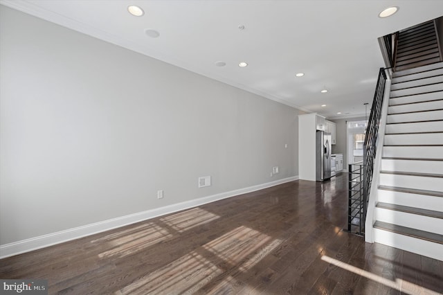 interior space featuring dark wood-type flooring, recessed lighting, crown molding, baseboards, and stairs