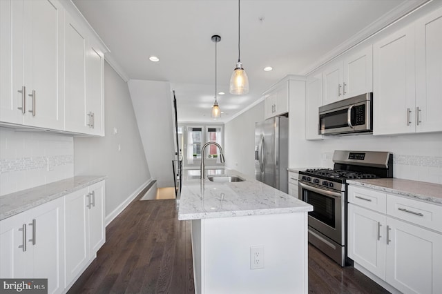 kitchen featuring white cabinets, crown molding, appliances with stainless steel finishes, dark wood-type flooring, and a sink