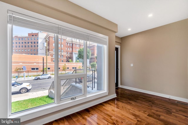 spare room featuring visible vents, recessed lighting, wood finished floors, and baseboards