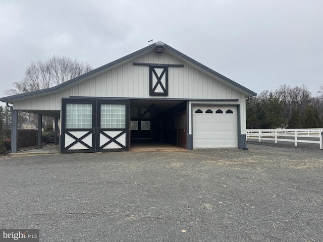 detached garage featuring fence