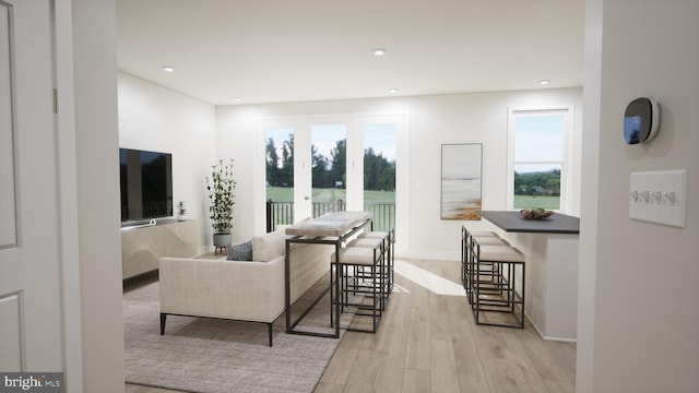 living room with light wood finished floors, recessed lighting, and baseboards