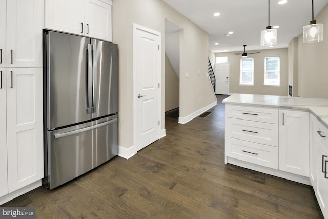 kitchen featuring white cabinets, dark wood-style flooring, and freestanding refrigerator