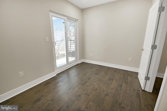 unfurnished room featuring dark wood finished floors and baseboards