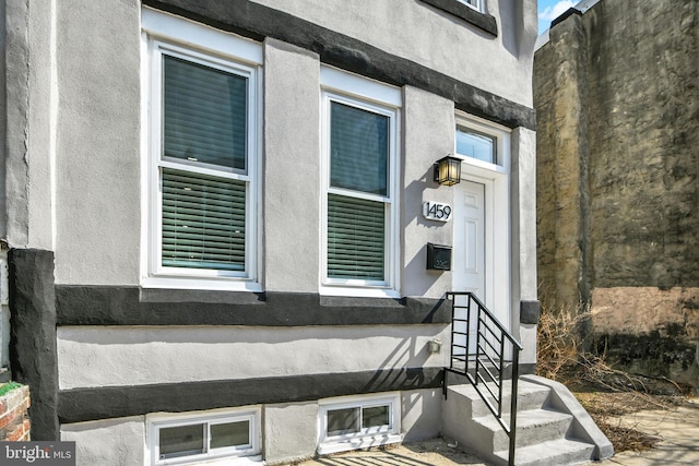 entrance to property with stucco siding