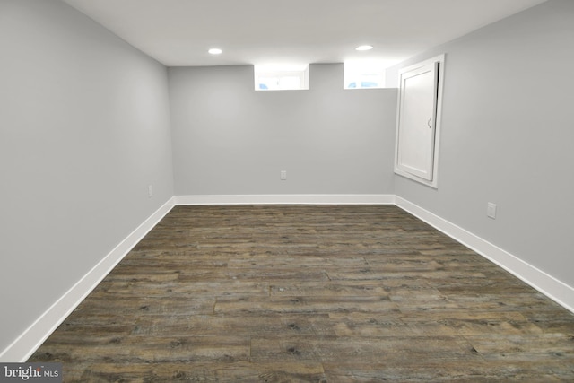 basement with recessed lighting, baseboards, and dark wood-style flooring