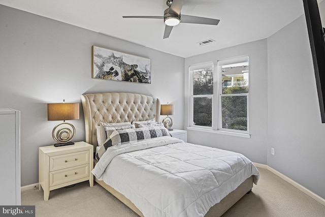 bedroom with visible vents, baseboards, ceiling fan, and carpet flooring