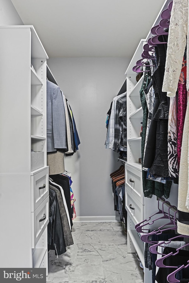 spacious closet with marble finish floor