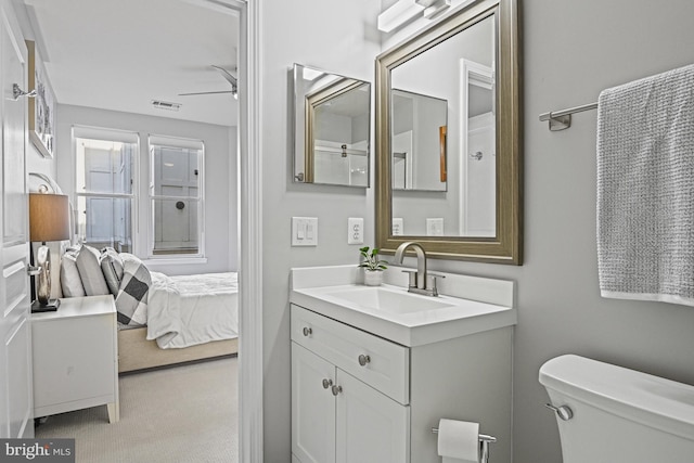 bathroom with visible vents, toilet, ensuite bath, and vanity