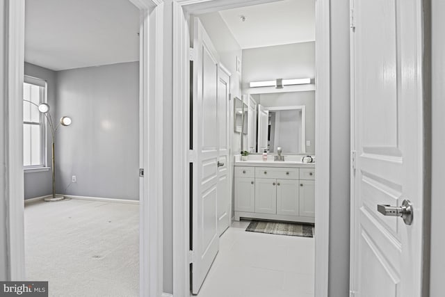 bathroom with vanity and baseboards