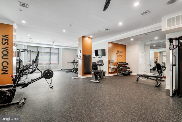 gym with crown molding, baseboards, and visible vents