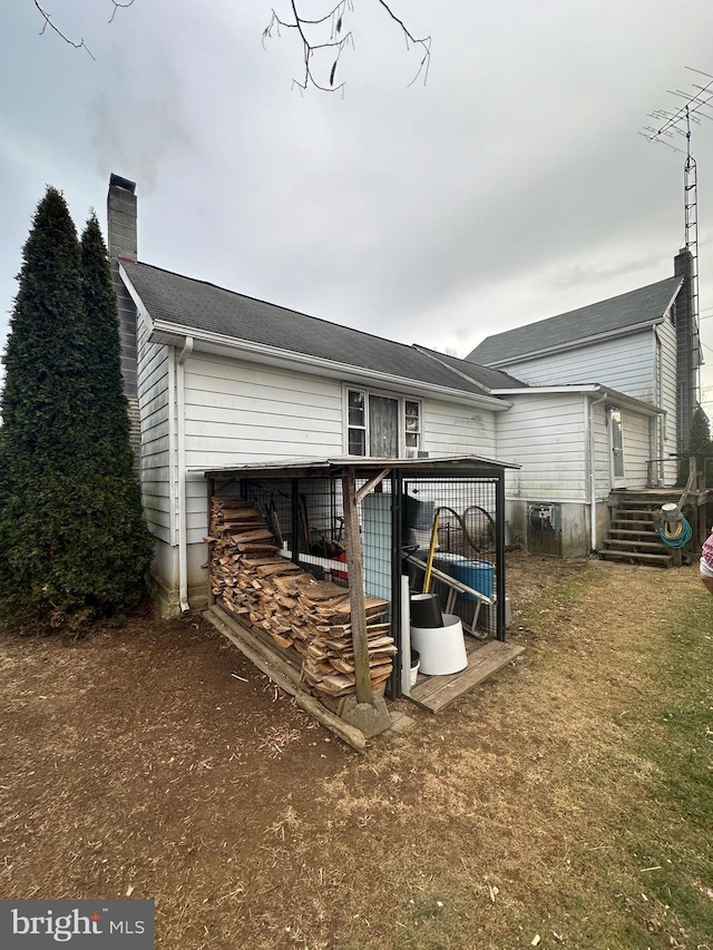 exterior space featuring a wooden deck and a chimney