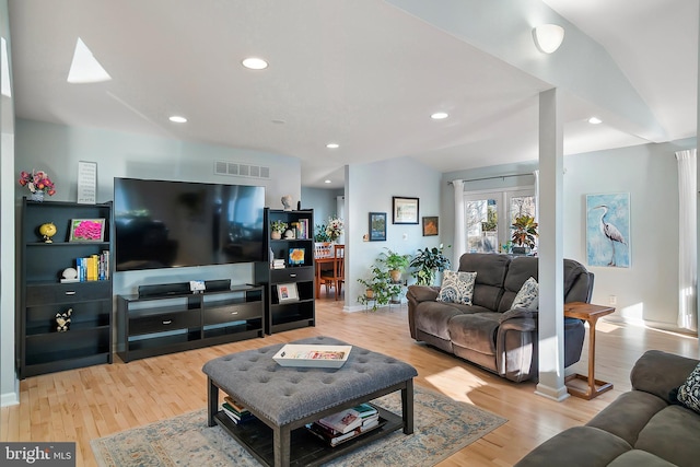 living room featuring recessed lighting, visible vents, and light wood-type flooring