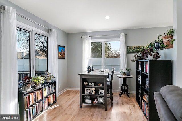 office space with light wood-style flooring and baseboards