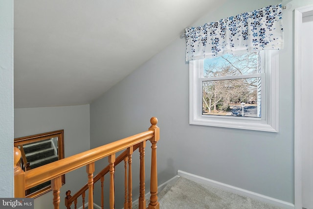 stairs with lofted ceiling, carpet flooring, and baseboards