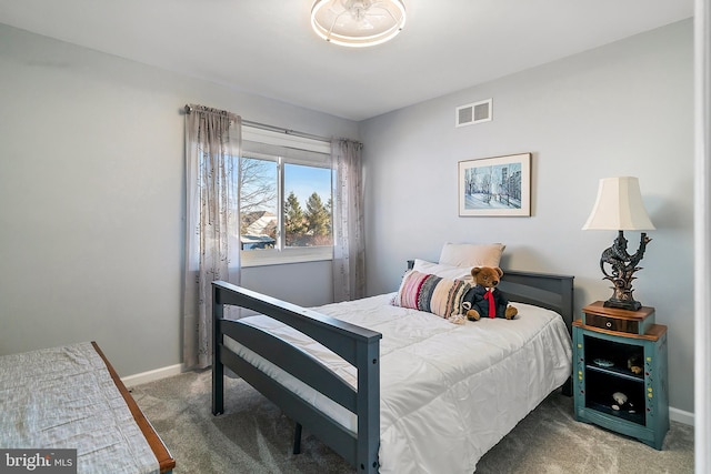 carpeted bedroom with baseboards and visible vents