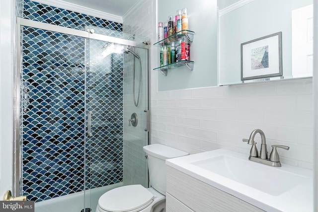 full bathroom featuring vanity, a stall shower, crown molding, tile walls, and toilet