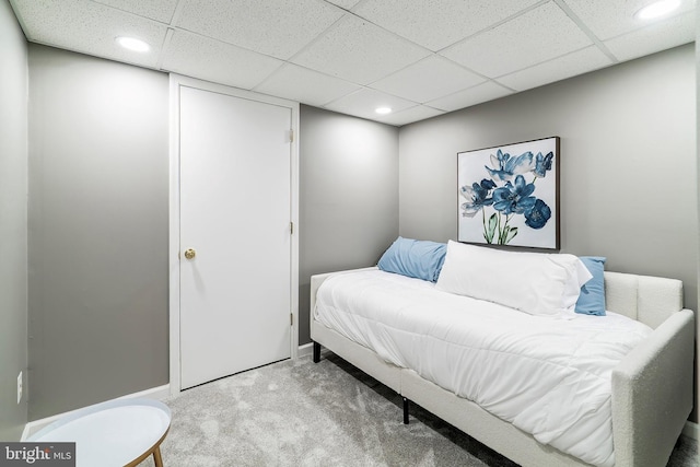 carpeted bedroom with recessed lighting, baseboards, and a drop ceiling