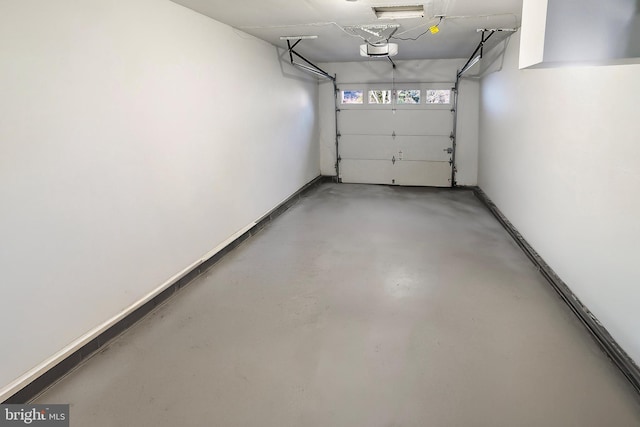 garage with a garage door opener and baseboards