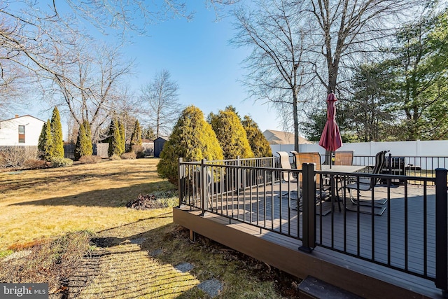 exterior space featuring an outdoor structure, outdoor dining area, and a fenced backyard