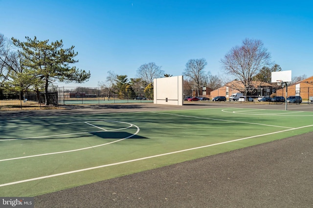 view of basketball court with community basketball court and fence