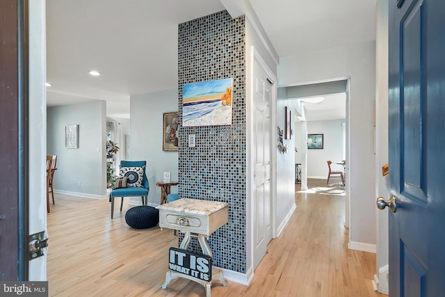 corridor featuring recessed lighting, baseboards, and light wood finished floors