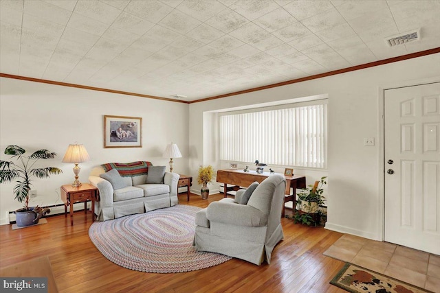 living area with crown molding, baseboards, visible vents, and wood-type flooring