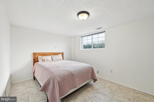 bedroom featuring baseboards, visible vents, and light tile patterned floors