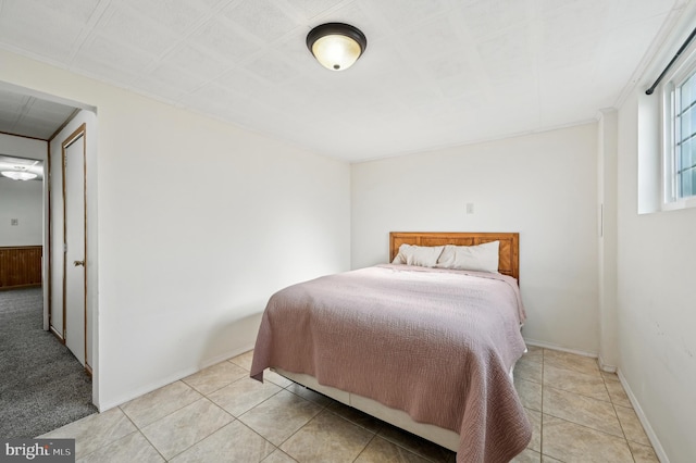 bedroom featuring light tile patterned flooring and baseboards