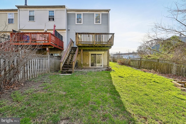 back of house featuring a fenced backyard, stairway, a yard, and a wooden deck