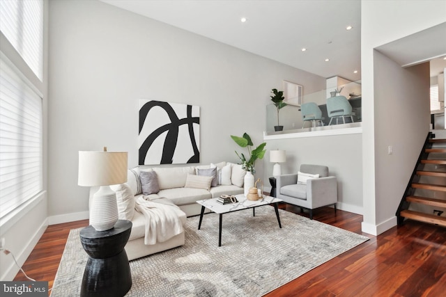 living room featuring stairway, recessed lighting, baseboards, and wood finished floors