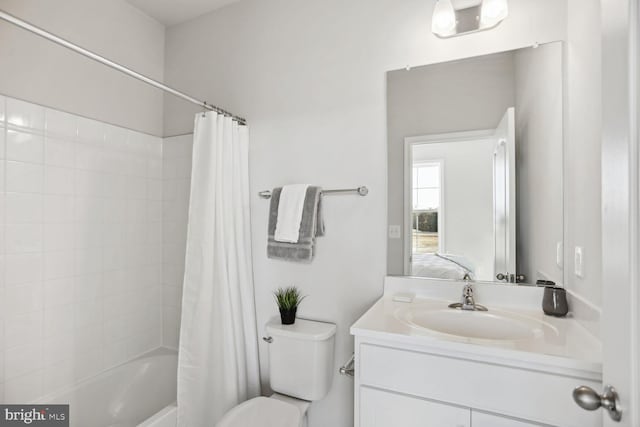 bathroom featuring shower / bath combo with shower curtain, toilet, and vanity