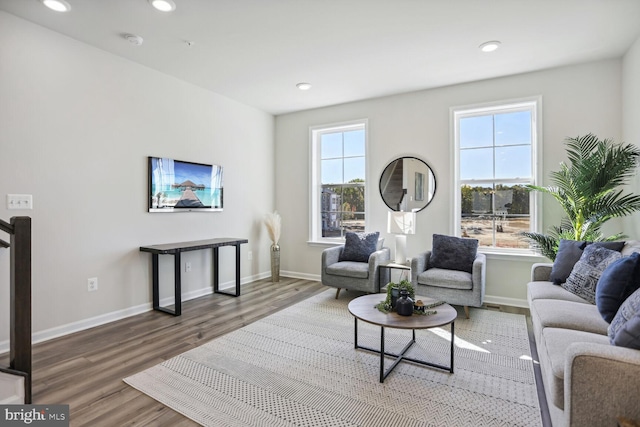 living room with recessed lighting, baseboards, and wood finished floors