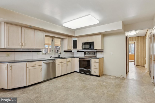 kitchen with stainless steel dishwasher, dark countertops, electric range oven, black microwave, and decorative backsplash