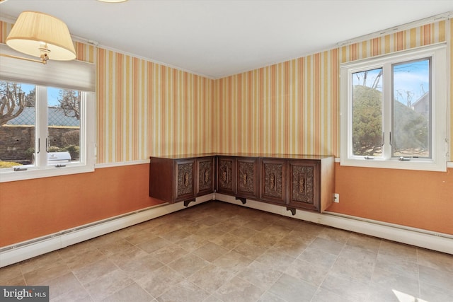 spare room featuring wallpapered walls and baseboards