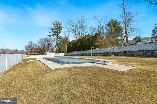 view of pool featuring fence private yard and a lawn