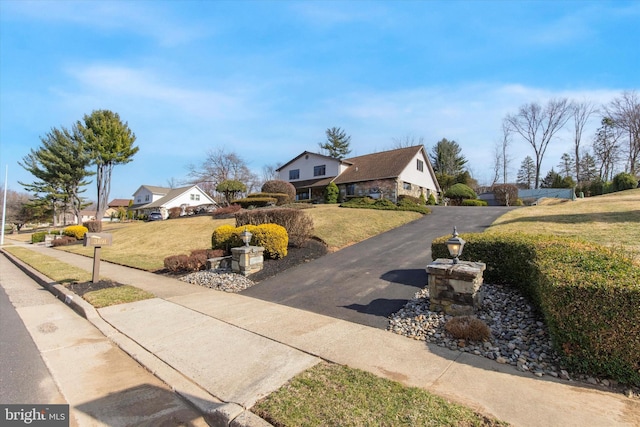 view of front facade featuring stone siding and a front lawn